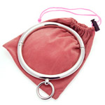 A shiny metal collar lying atop a pink drawstring bag.